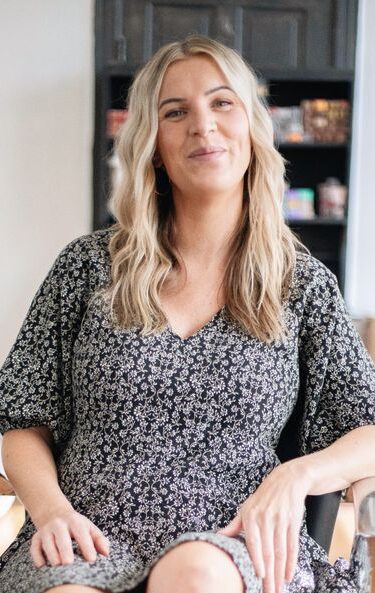 Chic and modern portrait of a woman stylist in a Brevard salon, exuding confidence and style.